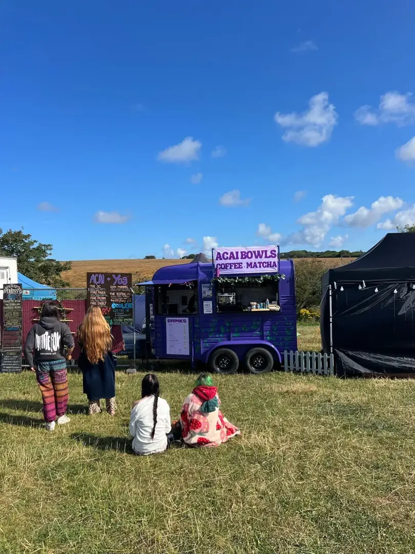 The purple horsebox set up in a sunny festival field
